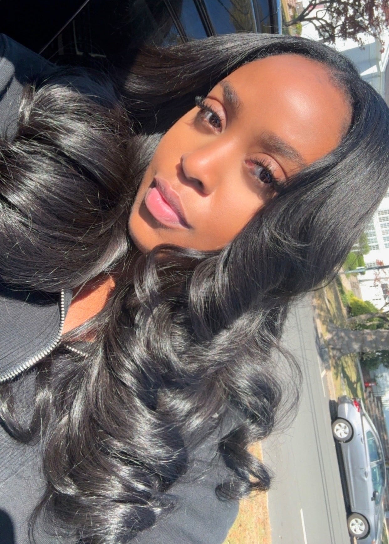 Woman with long, raw wavy hair extensions